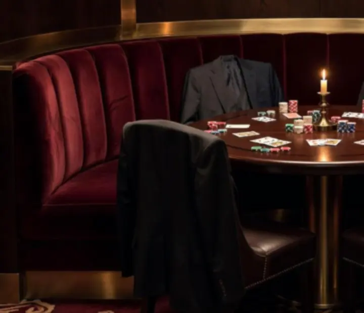 Private card lounge table with velvet drapes and soft lighting